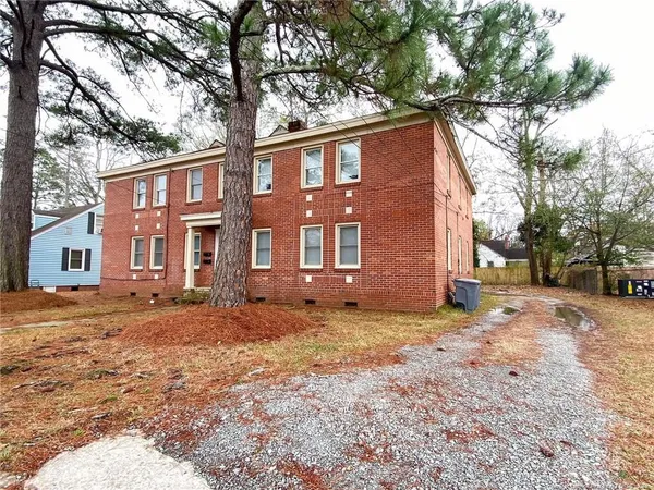a house that has a tree in front of it