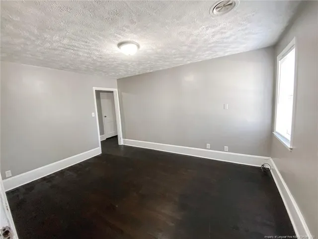 an empty room with wooden floor