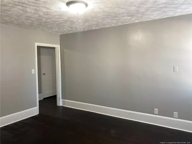 an empty room with wooden floor