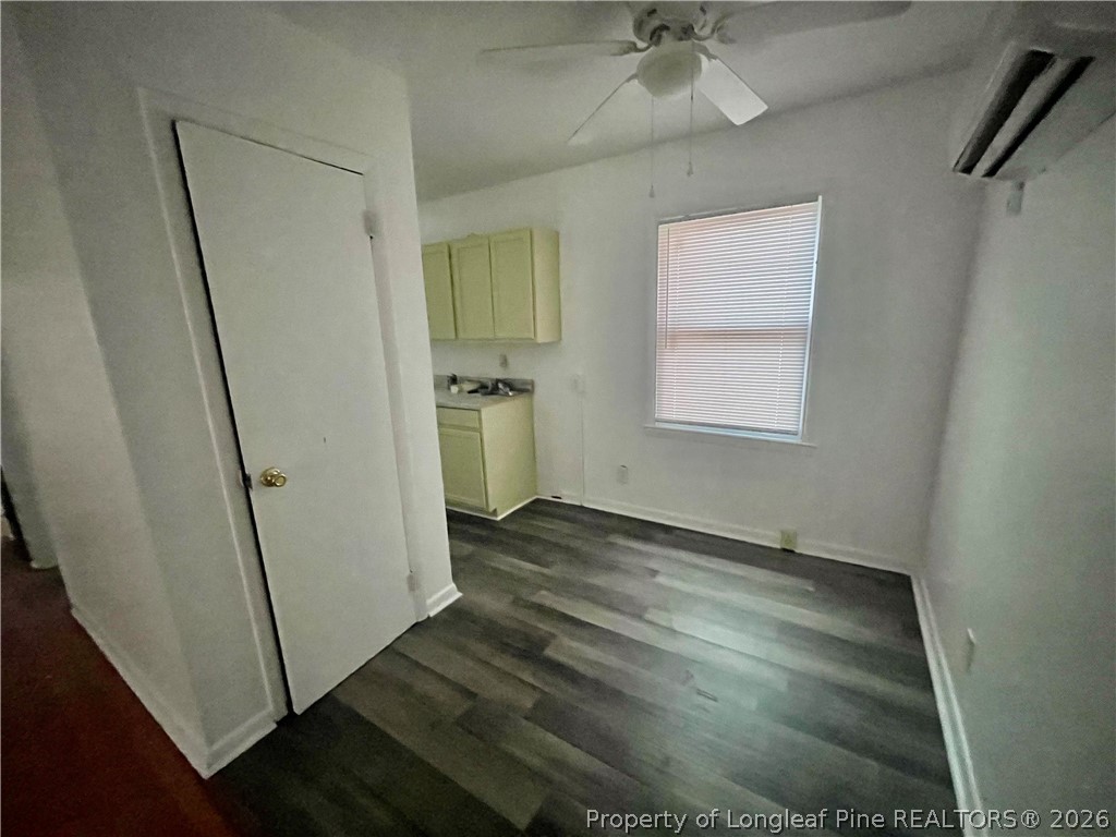 206 South 7th Street Spring Lake, NC 28390 - Photo 11 of 38 an empty room with wooden floor and a ceiling fan