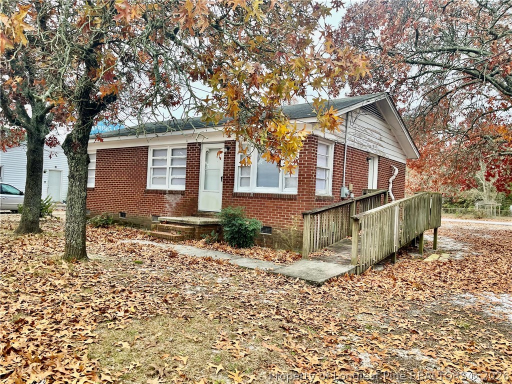 206 South 7th Street Spring Lake, NC 28390 - Photo 2 of 38 a view of a house with a yard covered in snow