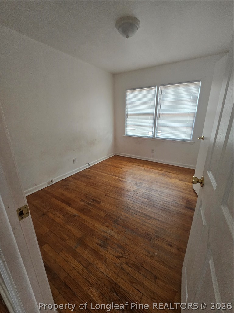 206 South 7th Street Spring Lake, NC 28390 - Photo 24 of 38 an empty room with wooden floor and windows