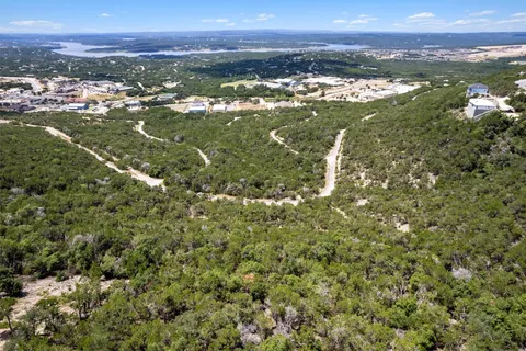 an aerial view of residential houses with outdoor space and river