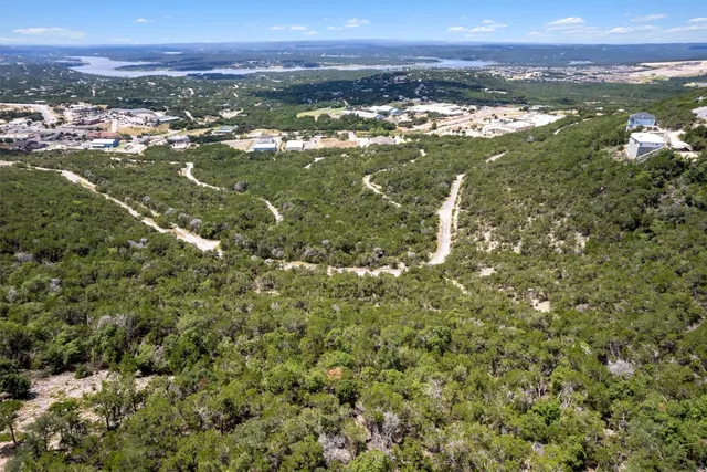 an aerial view of residential houses with outdoor space and river