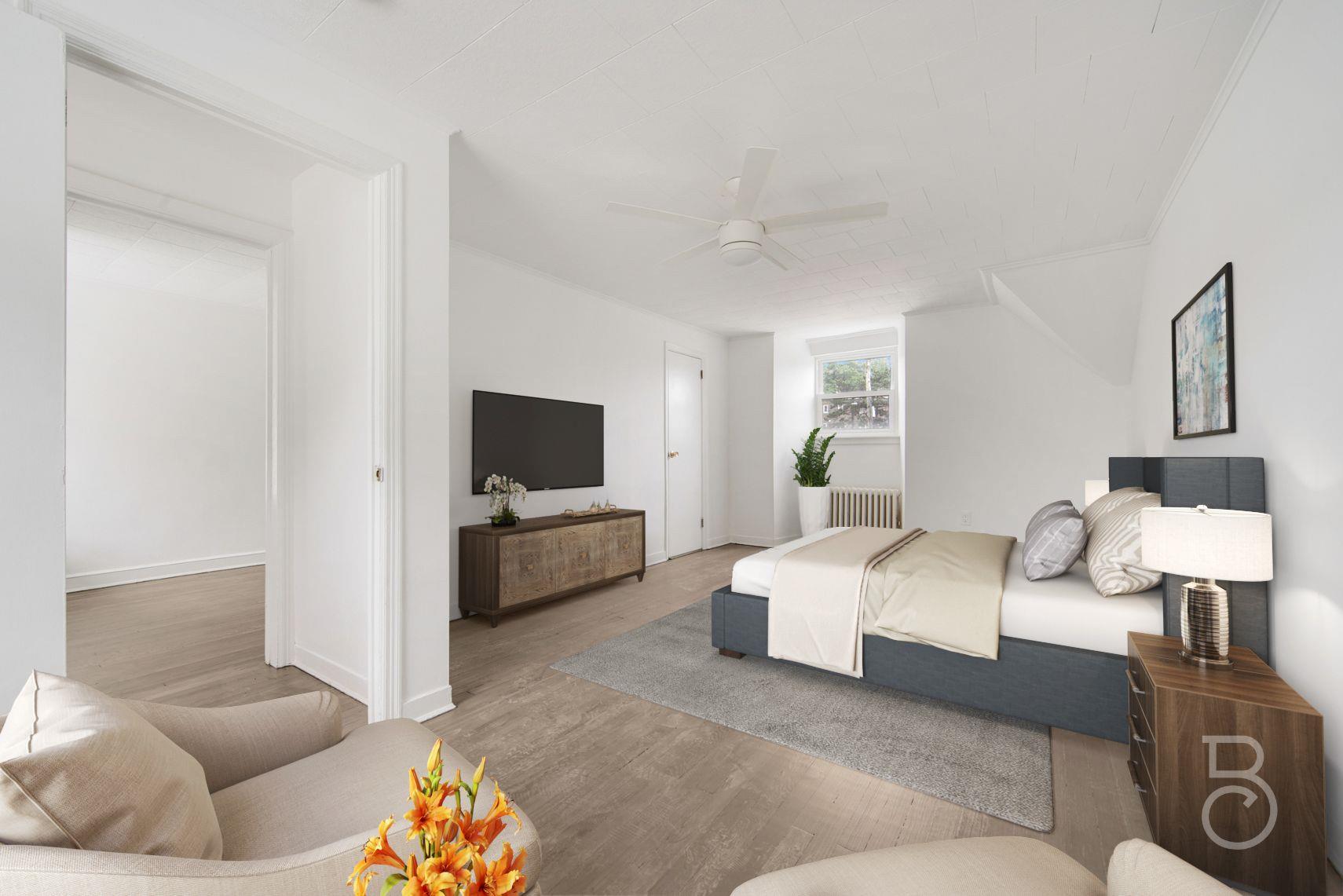 53-66 62nd Street Queens, NY 11378 - Photo 15 of 19 a spacious bedroom with a bed and lamp