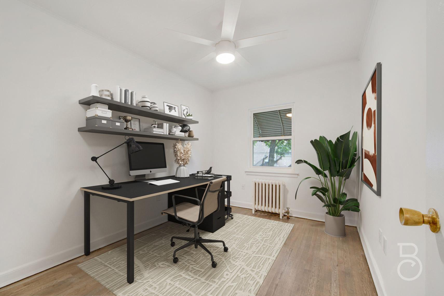 53-66 62nd Street Queens, NY 11378 - Photo 17 of 19 a view of a workspace with furniture and a potted plant