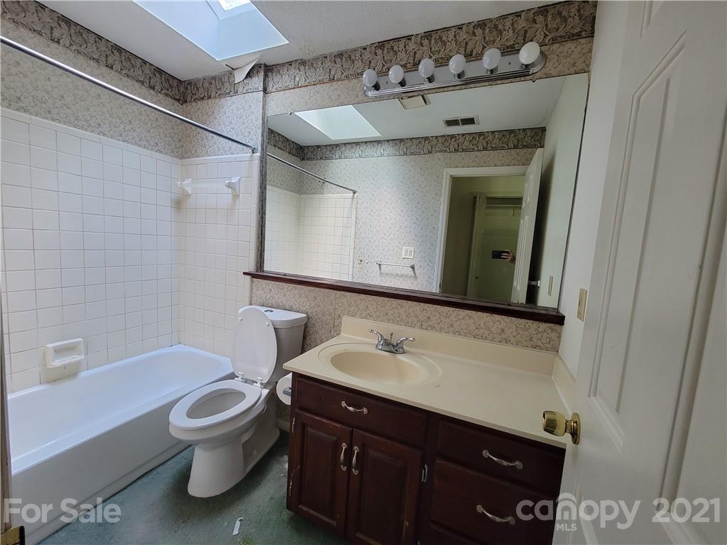 9640 Surrey Road Mint Hill, NC 28227 - Photo 15 of 18 a bathroom with a sink a toilet and shower