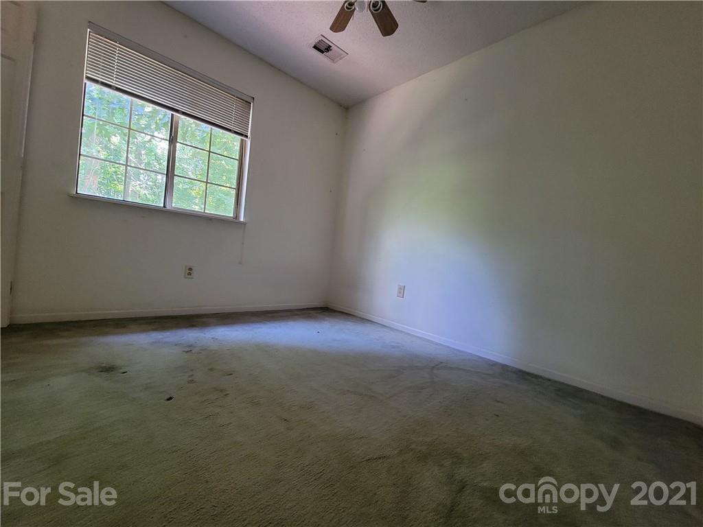 9640 Surrey Road Mint Hill, NC 28227 - Photo 17 of 18 an empty room with a window and a ceiling fan view