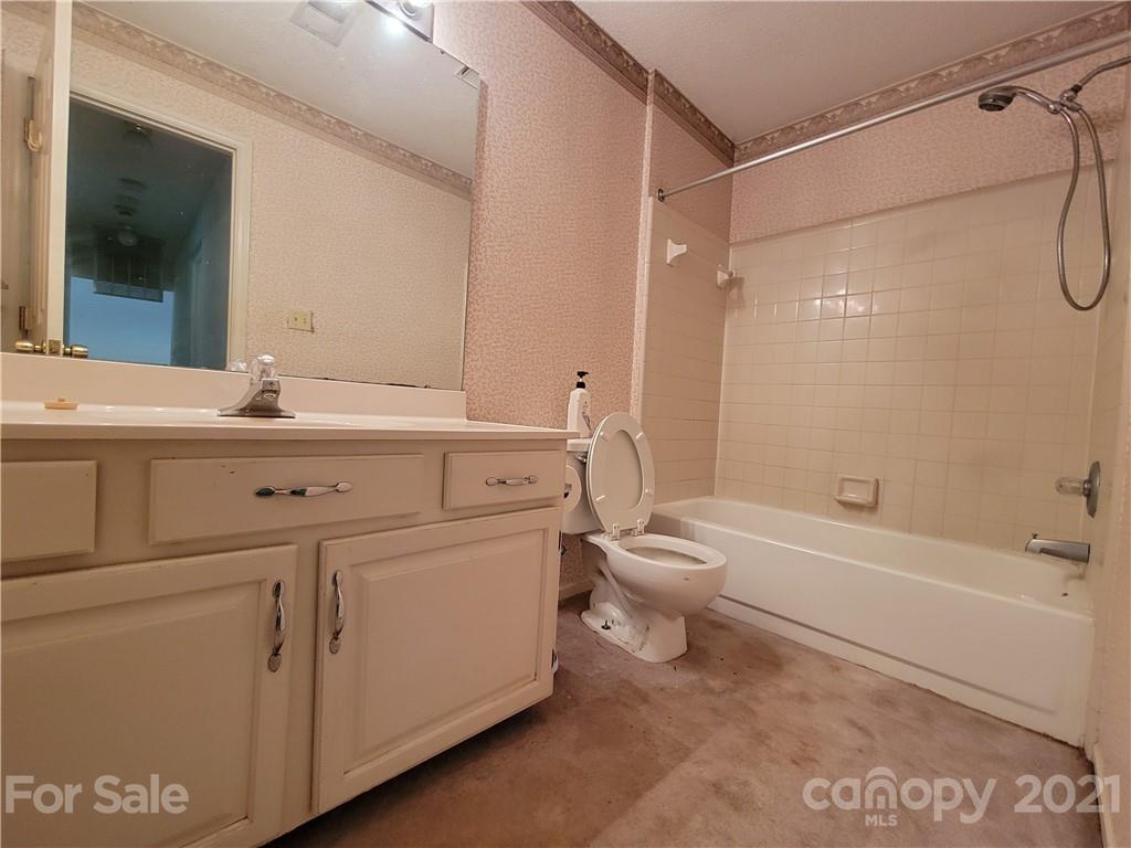 9640 Surrey Road Mint Hill, NC 28227 - Photo 18 of 18 a bathroom with a sink a toilet and shower