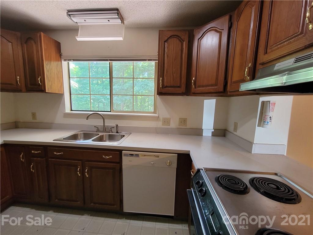 9640 Surrey Road Mint Hill, NC 28227 - Photo 7 of 18 a kitchen with stainless steel appliances granite countertop a sink a stove and a microwave