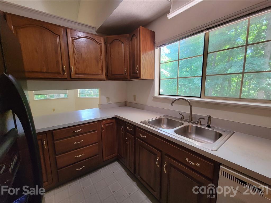 9640 Surrey Road Mint Hill, NC 28227 - Photo 8 of 18 a kitchen with stainless steel appliances granite countertop a sink window and cabinets