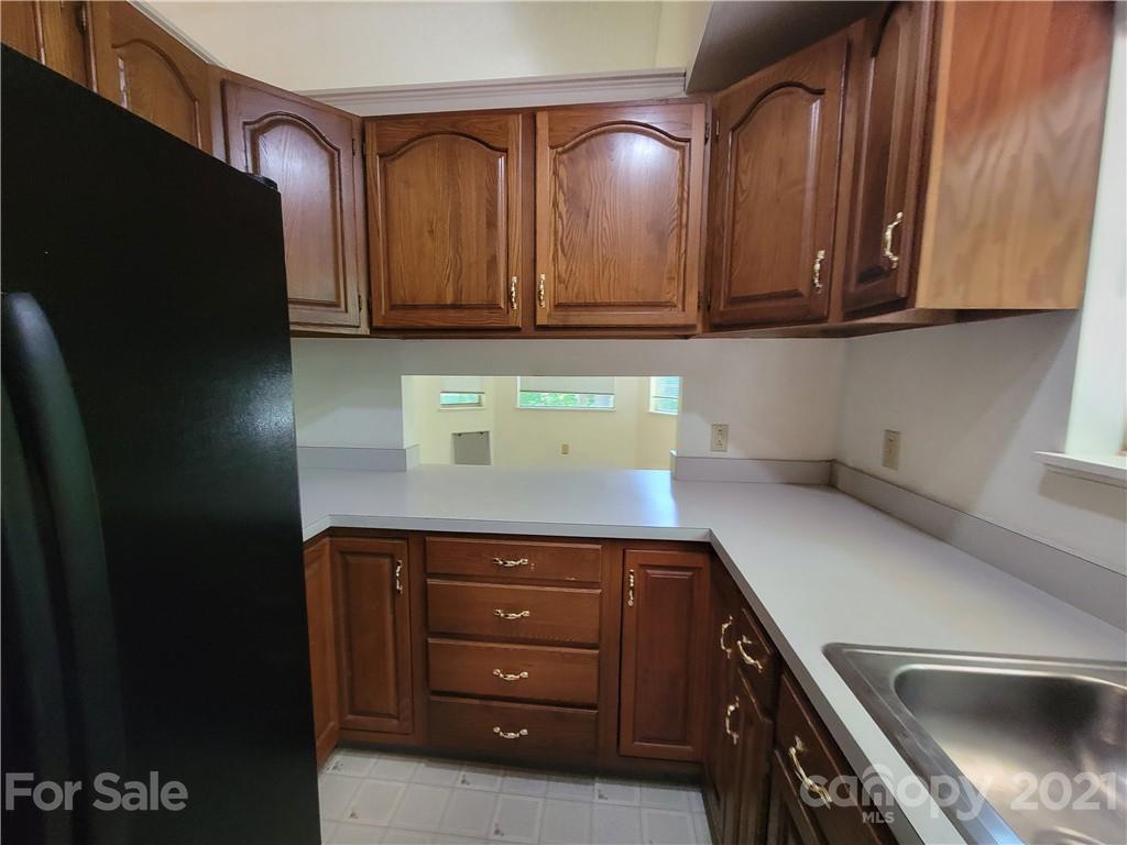 9640 Surrey Road Mint Hill, NC 28227 - Photo 9 of 18 a kitchen with a sink and cabinets
