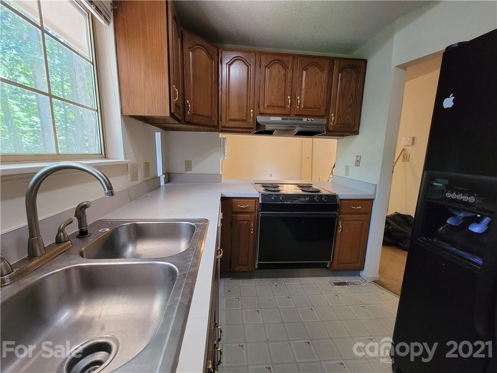 9640 Surrey Road Mint Hill, NC 28227 - Photo 10 of 18 a kitchen with a sink stove and cabinets