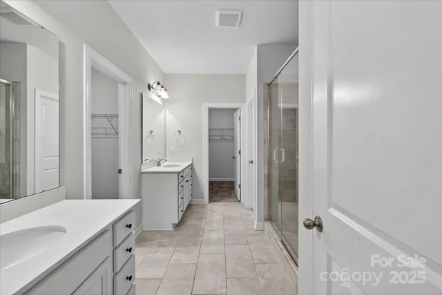 a spacious bathroom with a double vanity sink mirror and double