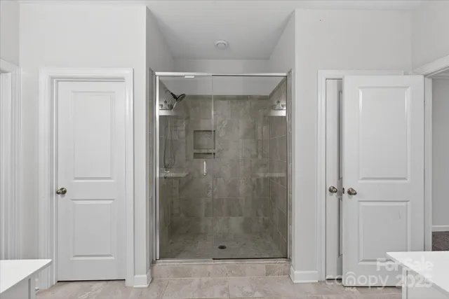 a bathroom with a granite countertop sink mirror and shower