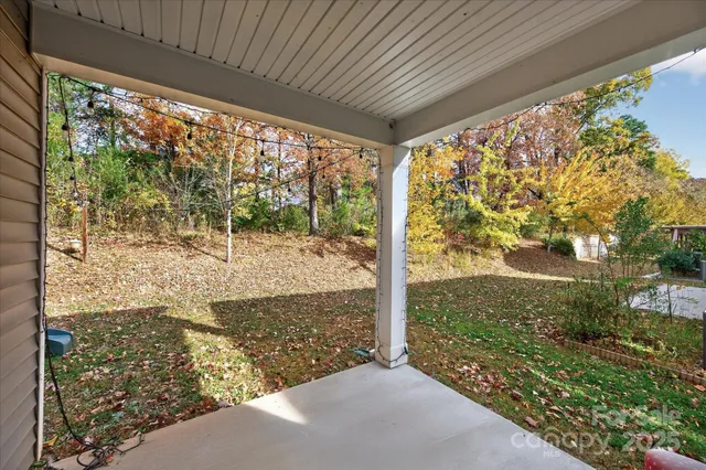 a wooden bench sitting in the middle of a yard