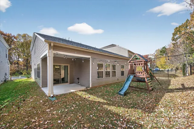 a view of a house with backyard and sitting area