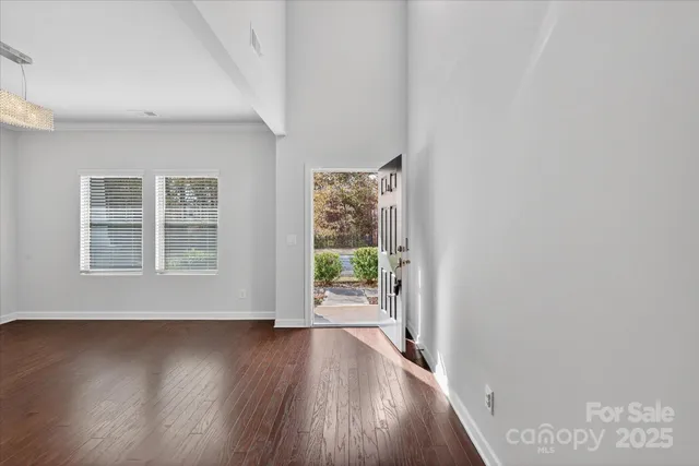 a view of hallway with wooden floor and front door