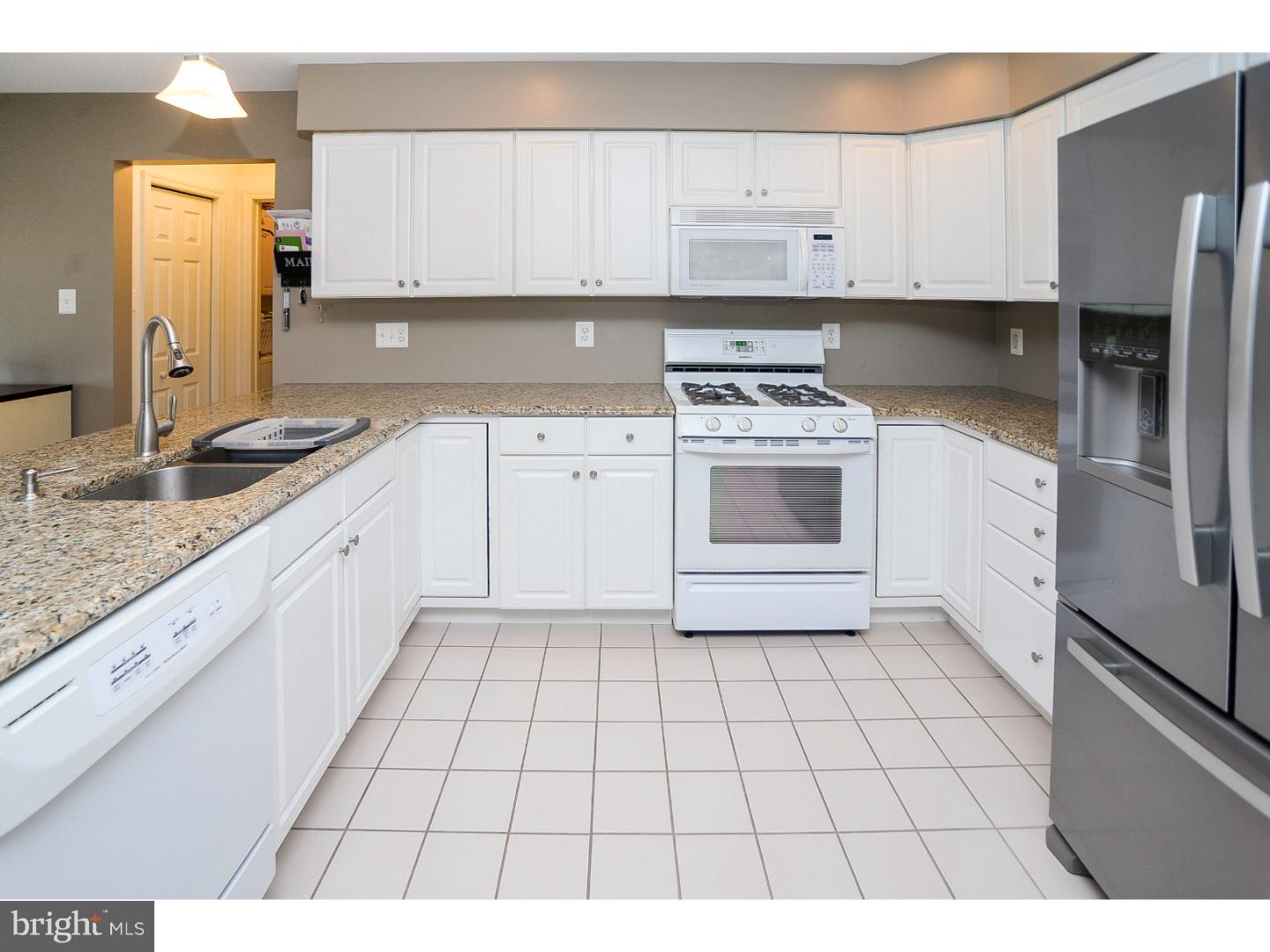 22 Stone Ridge Drive Mickleton, NJ 08056 - Photo 3 of 25 a kitchen with a stove a sink and a refrigerator