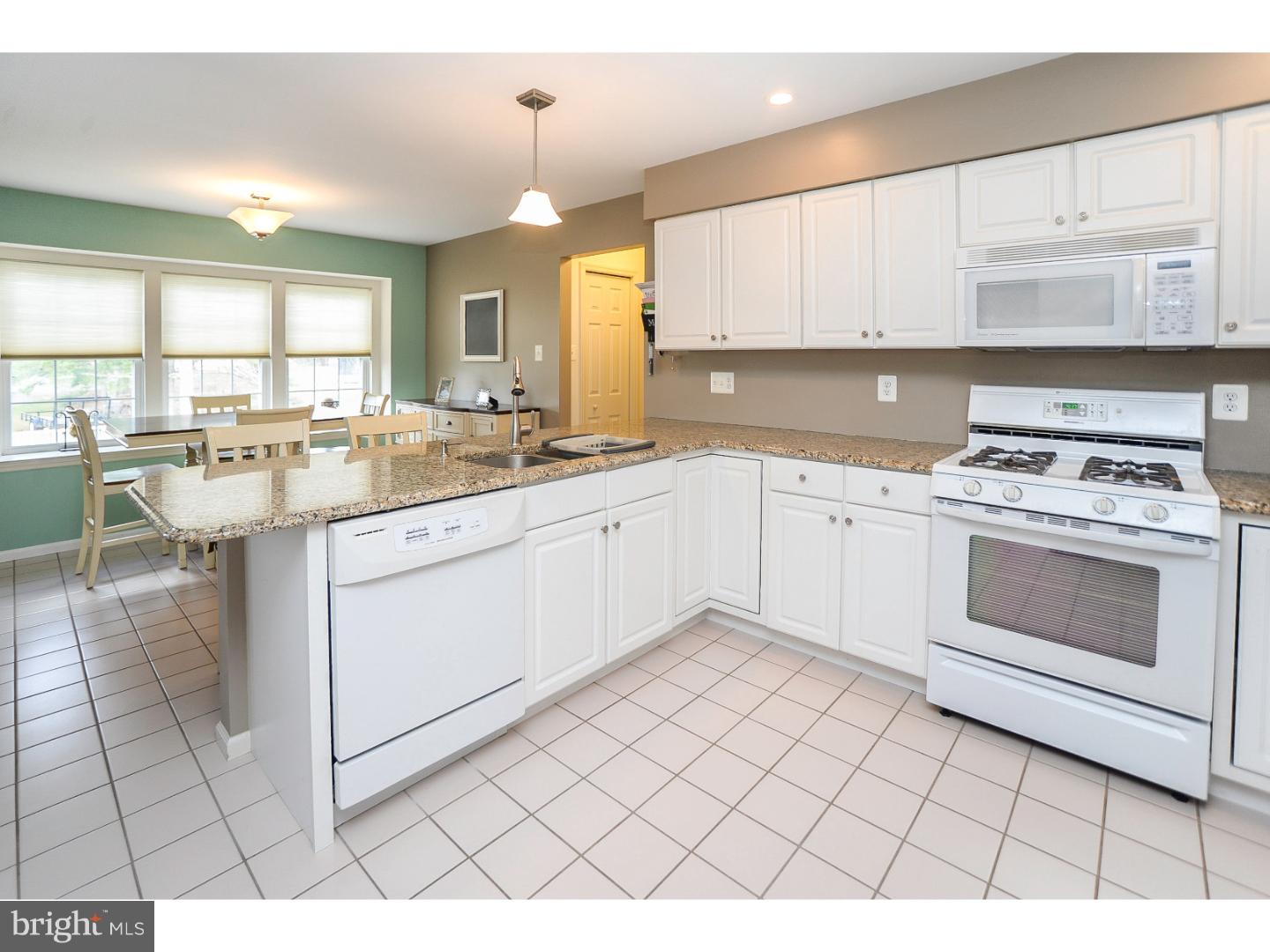 22 Stone Ridge Drive Mickleton, NJ 08056 - Photo 4 of 25 a kitchen with a sink stove and cabinets