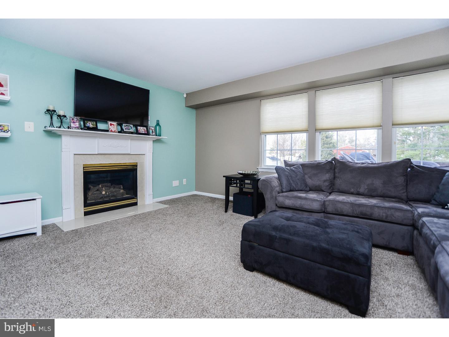 22 Stone Ridge Drive Mickleton, NJ 08056 - Photo 5 of 25 a living room with furniture a fireplace and a flat screen tv