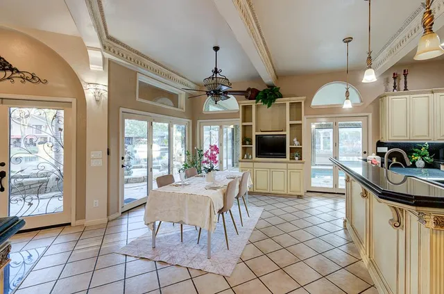 a kitchen with white cabinets and appliances