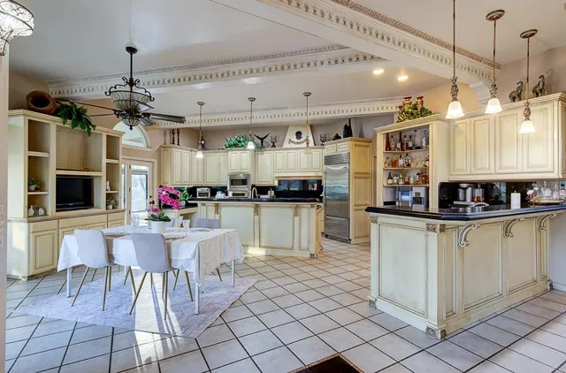 a kitchen with kitchen island granite countertop stainless steel appliances lots of counter top space