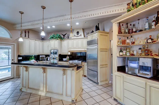 a bedroom with a bed and a table chair