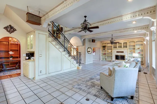 a hallway with furniture and a large window