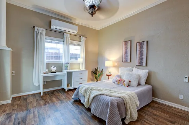 a spacious bedroom with a large bed and a large window