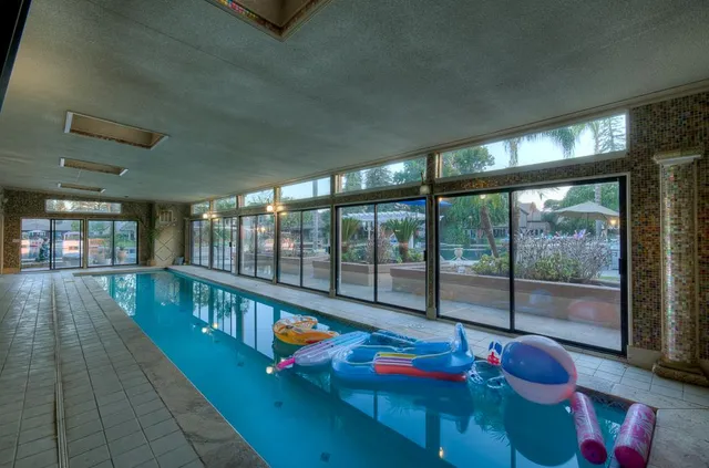 a spacious bedroom with a bed and a chandelier