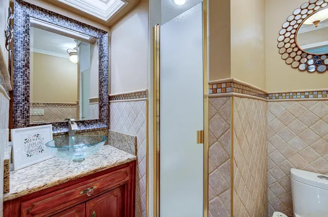 a spacious bathroom with a granite countertop sink and a mirror