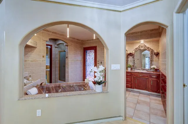 a bathroom with a sink a toilet a mirror and shower