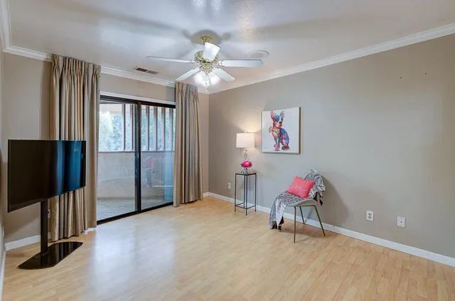 a view of a patio with couches and a fire pit and potted plants