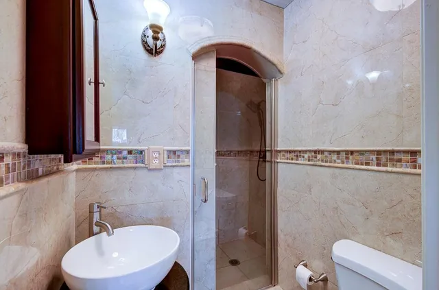 a view of a chairs and table under an umbrella in patio