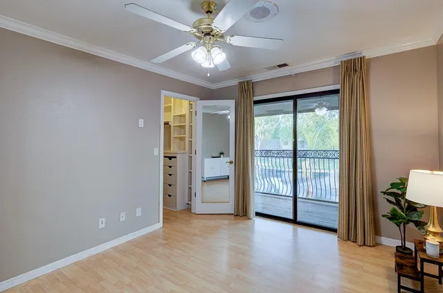 a view of a patio with a table and chairs and potted plants