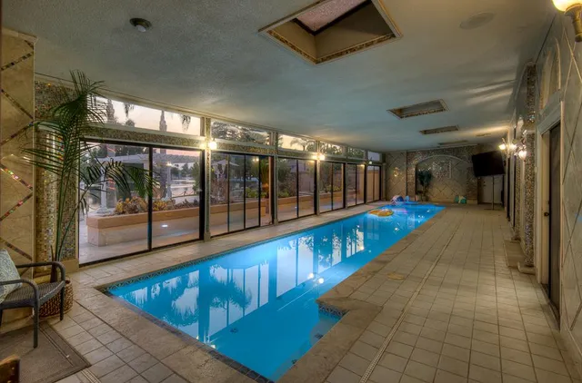 a view of a patio with couches table and chairs and potted plants