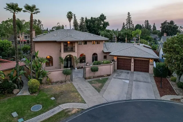 a living room with fireplace furniture and a large window