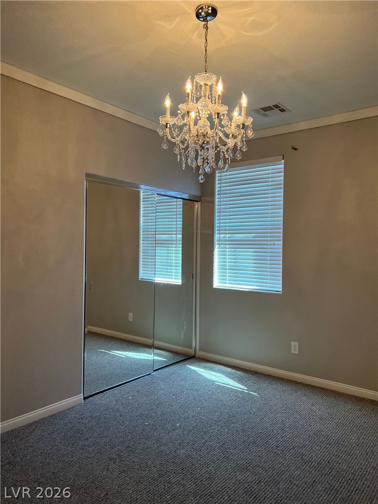 5981 Honeysuckle Ridge Street Las Vegas, NV 89148 - Photo 23 of 29 A shimmering chandelier illuminates this bedroom, offering a delightful focal point.