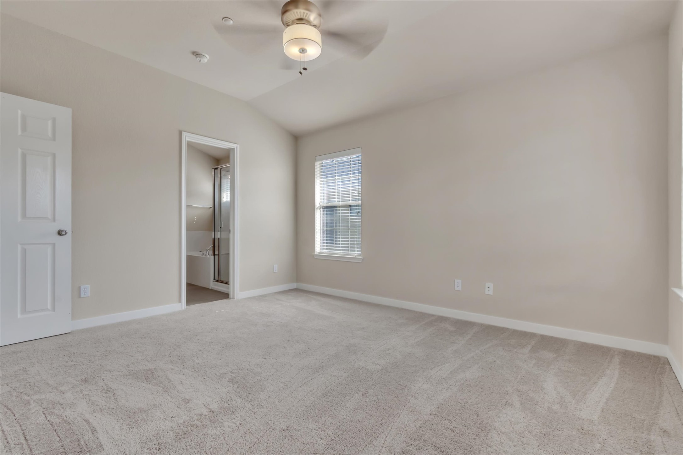 14815 Avery Ranch Boulevard, Unit 2A Austin, TX 78717 - Photo 19 of 27 Well-lit primary bedroom featuring soft carpeting and a private bath entrance.