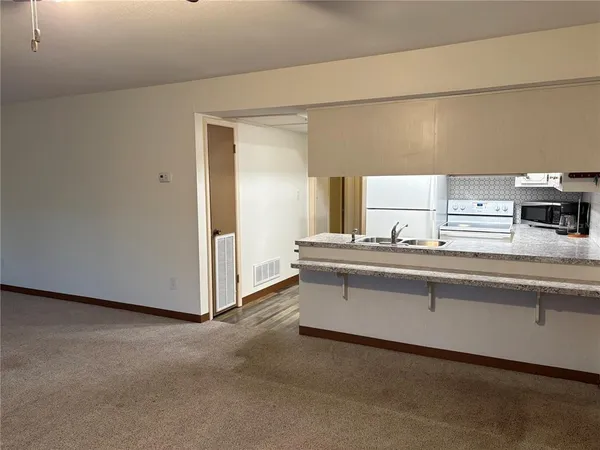 a spacious bathroom with a double vanity sink and a mirror