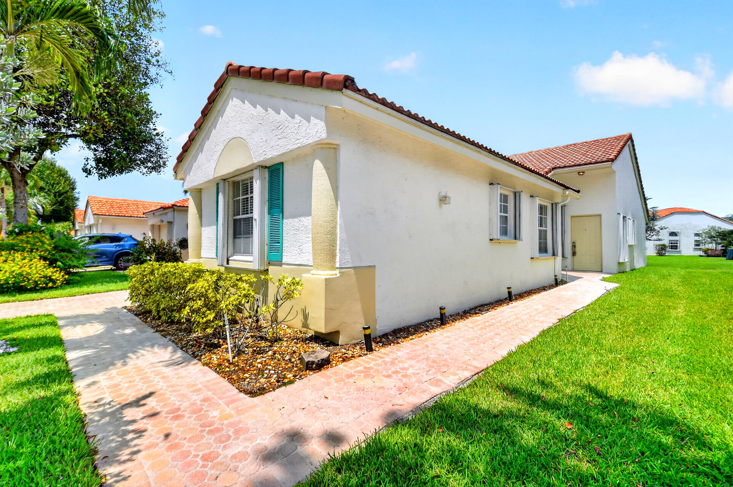 15340 Floral Club Road Delray Beach, FL 33484 - Photo 2 of 42 a front view of a house with a yard and garage