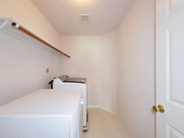 an empty room with wooden floor ceiling fan and windows