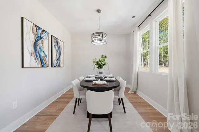 a view of a dining room with furniture window and wooden floor
