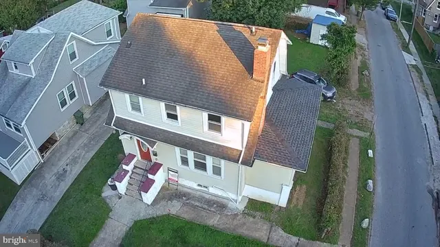an aerial view of a house with a garden and trees