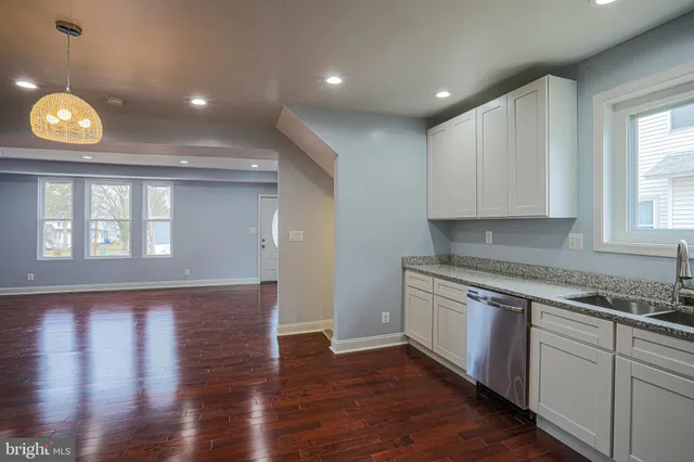 a open kitchen with window and wooden floor