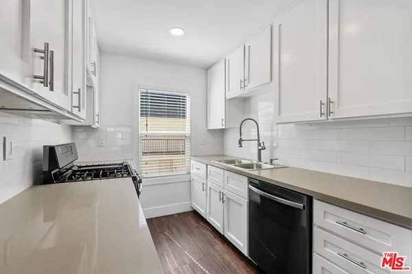 a kitchen that has a sink and cabinets