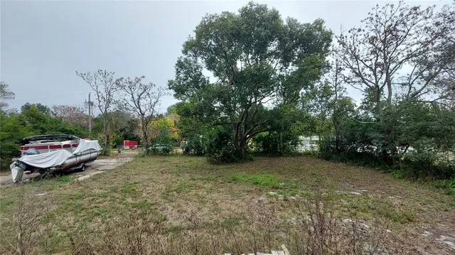 a backyard of a house with barbeque oven table and chairs