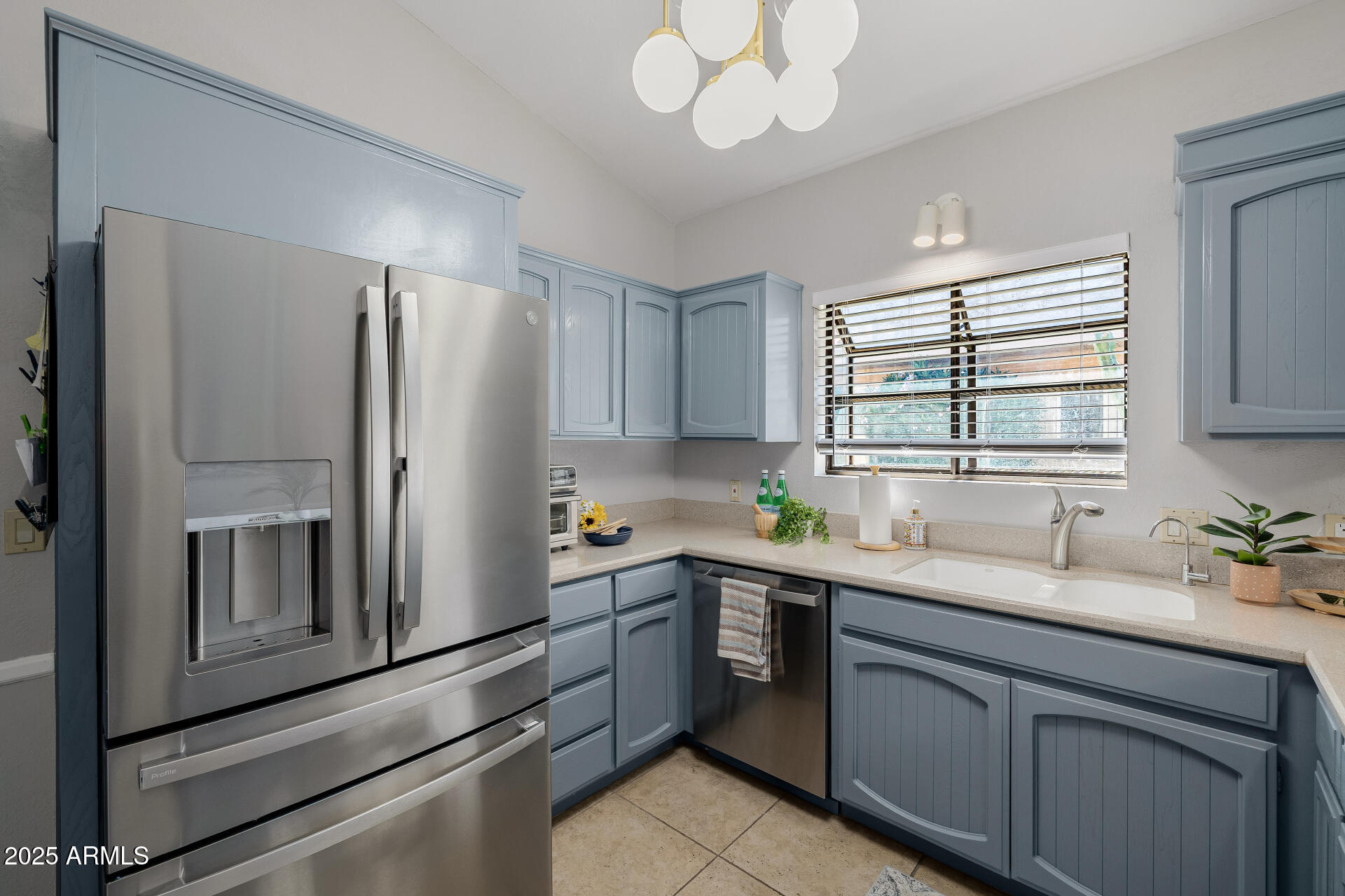 7615 East Tucson Road Scottsdale, AZ 85258 - Photo 14 of 54 a kitchen with a sink stainless steel appliances cabinets and a window