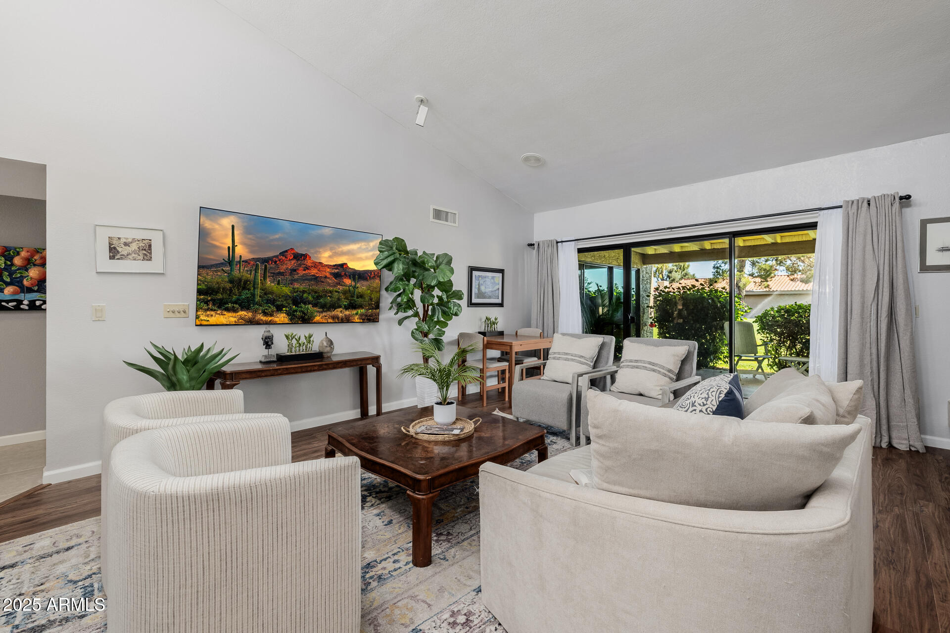 7615 East Tucson Road Scottsdale, AZ 85258 - Photo 7 of 54 a living room with furniture a flat screen tv and a large window